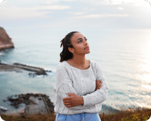 woman in a white cable-knit sweater
