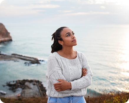 woman in a white cable-knit sweater