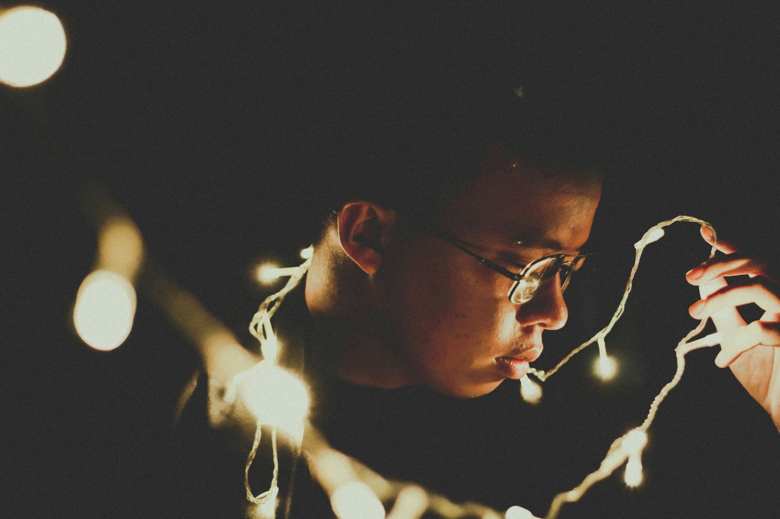 shows a person holding string lights